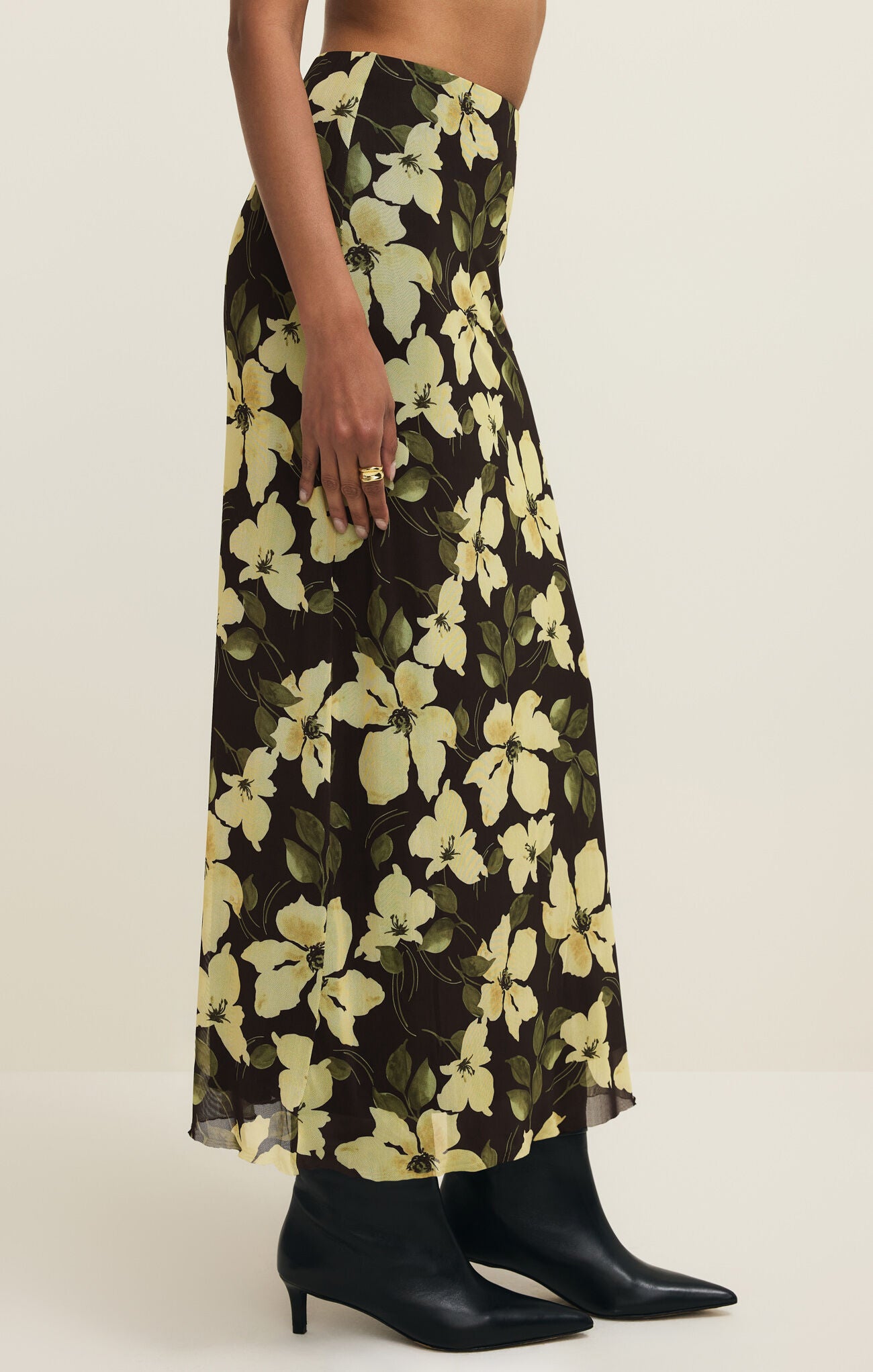 Floral patterned skirt worn by a person on a white background
