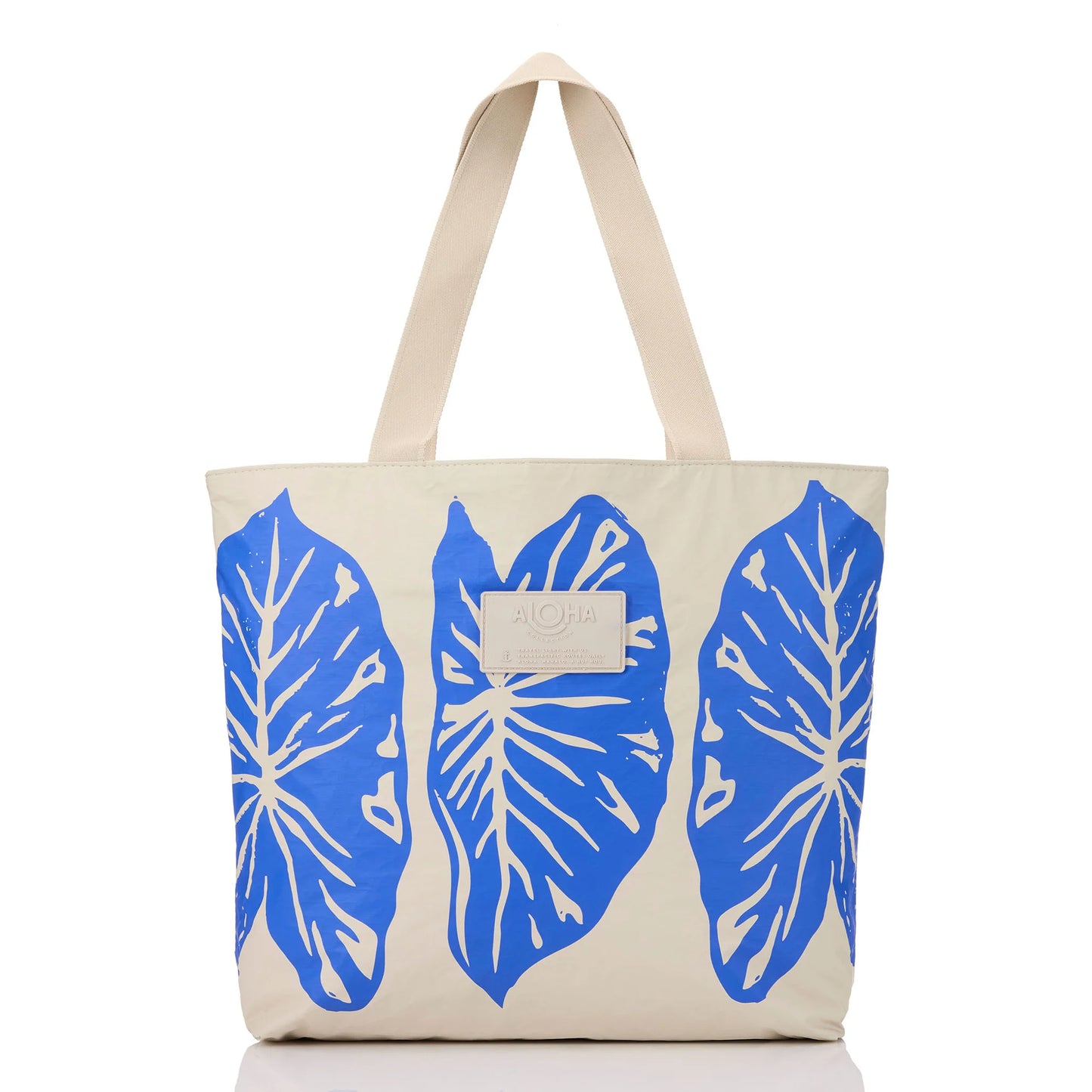 Beige tote bag with blue leaf patterns on a white background