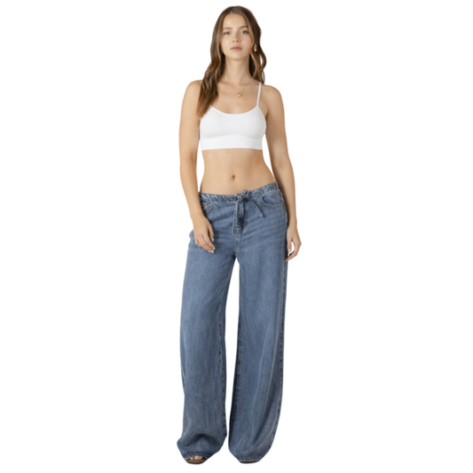 Woman in white tank bra top.