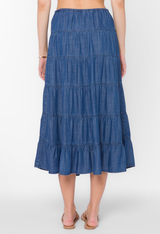 Blue tiered skirt worn by a person on a white background