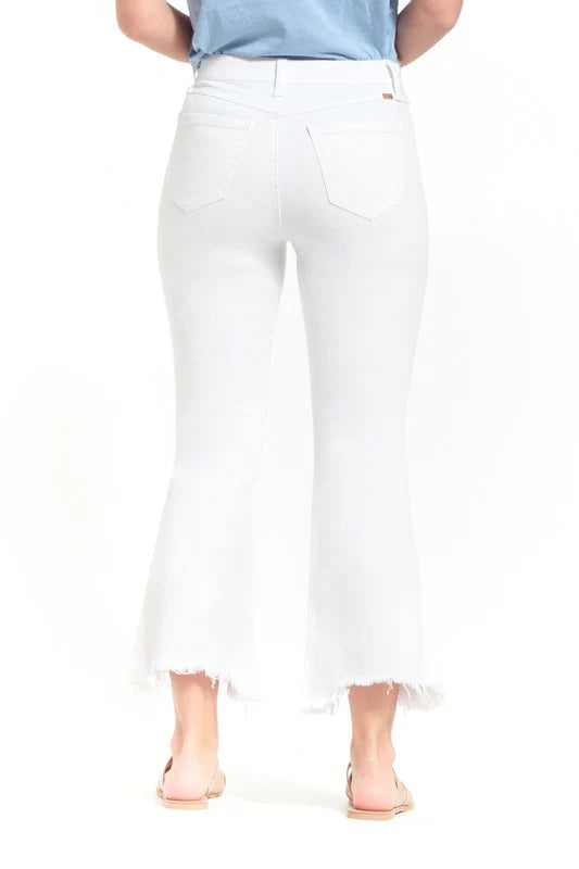 White jeans worn by a person on a white background