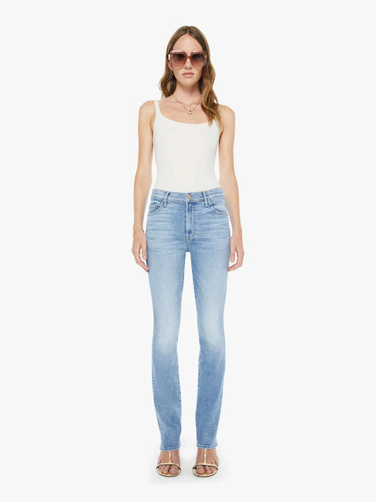 Woman wearing light blue jeans and a white top on a white background