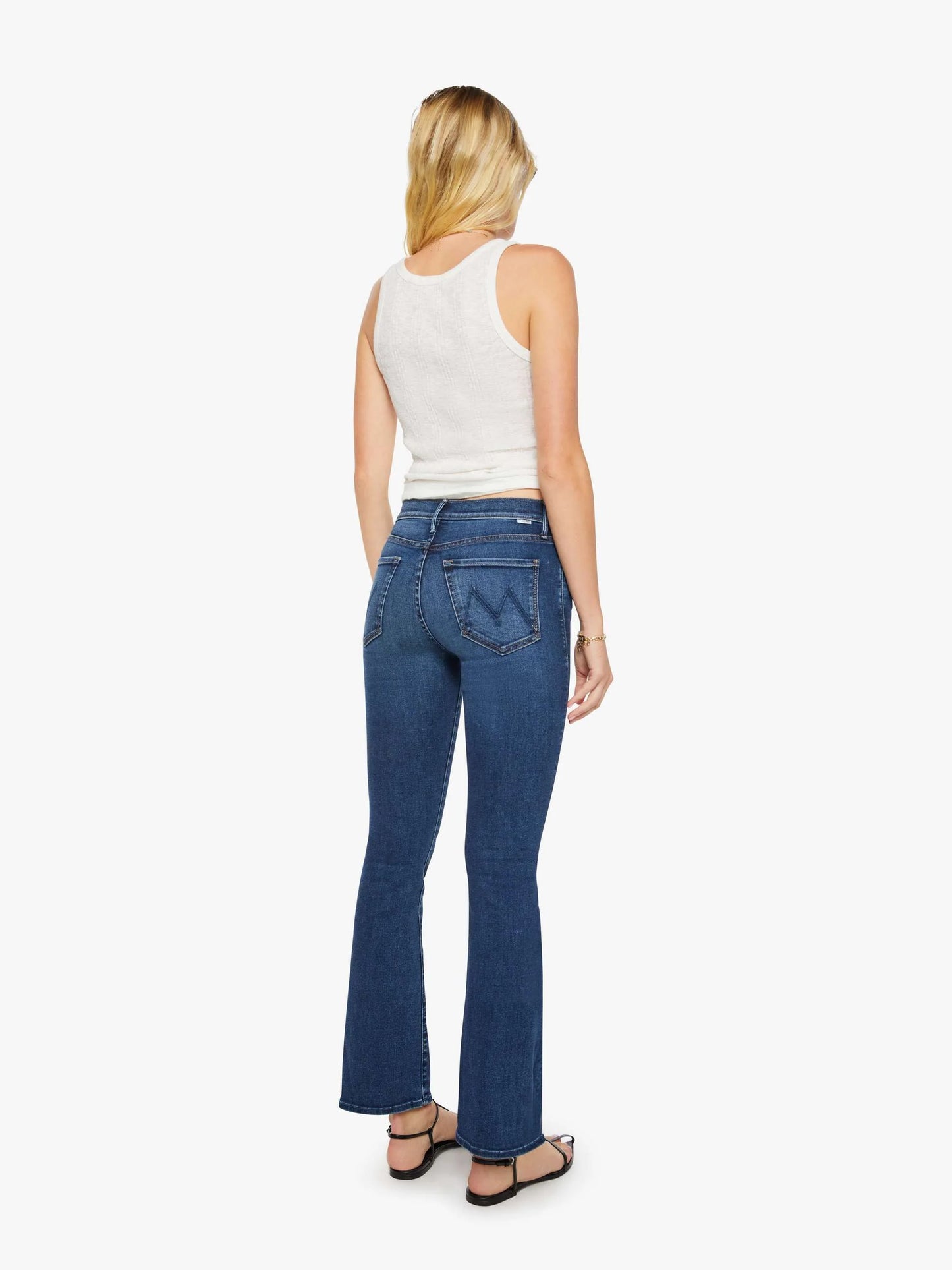 Woman wearing blue jeans on a white background