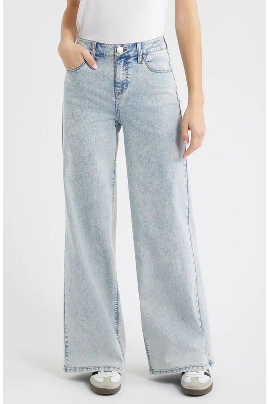 Light blue jeans worn by a person on a white background