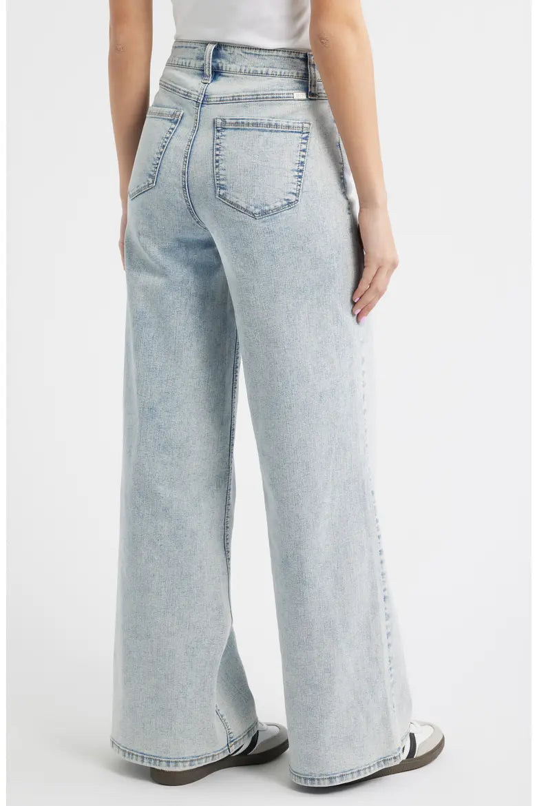 Light blue jeans worn by a person on a white background