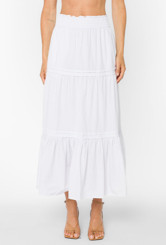 White tiered skirt worn by a person on a white background
