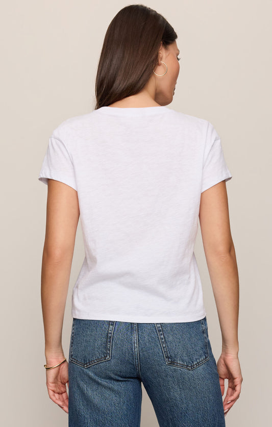 Person wearing a white t-shirt and blue jeans on a beige background
