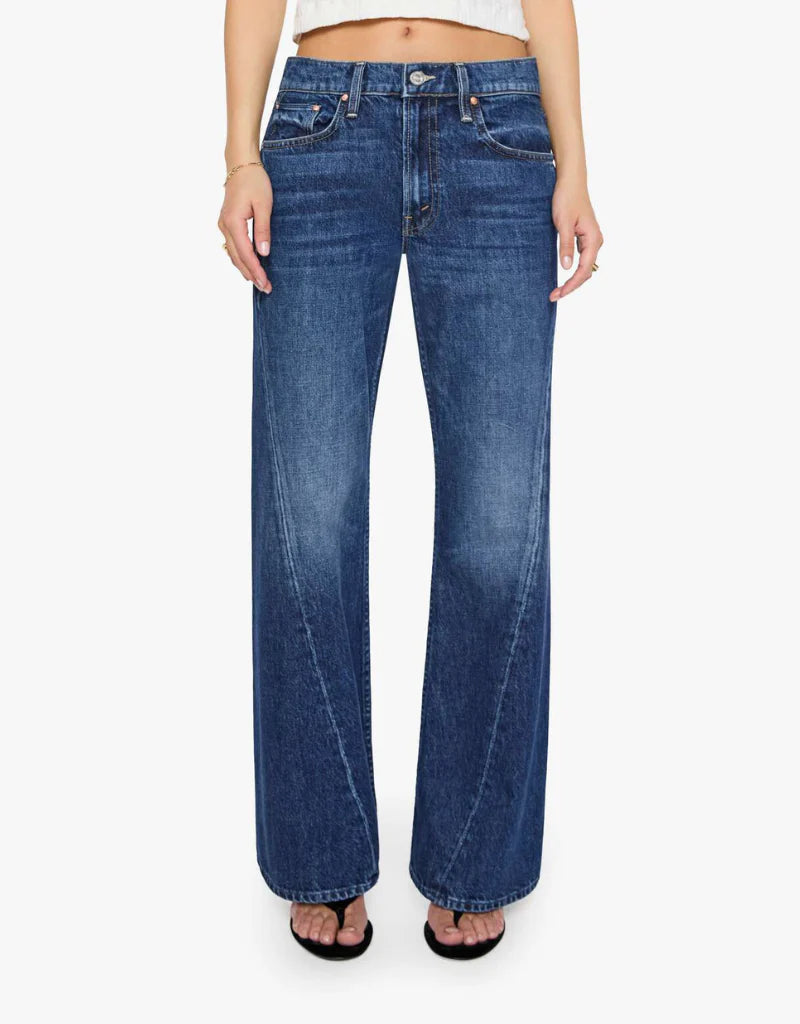 A model wearing a pair of medium-wash blue wide-leg jeans, shown from the waist down against a plain white background.