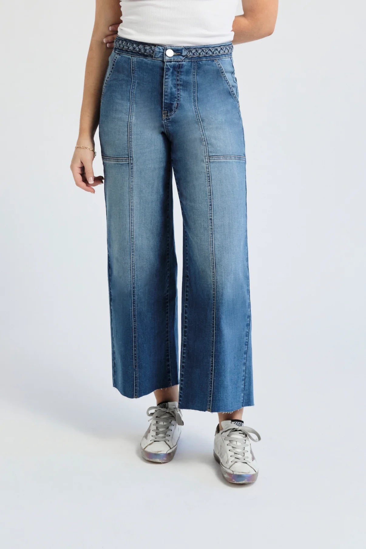 Person wearing denim jeans facing forward.