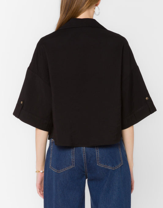 Person wearing a black shirt and blue jeans on a white background