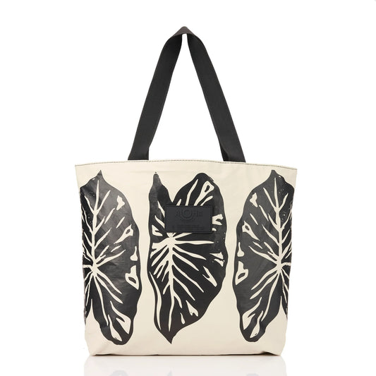Tote bag with black leaf patterns on a white background