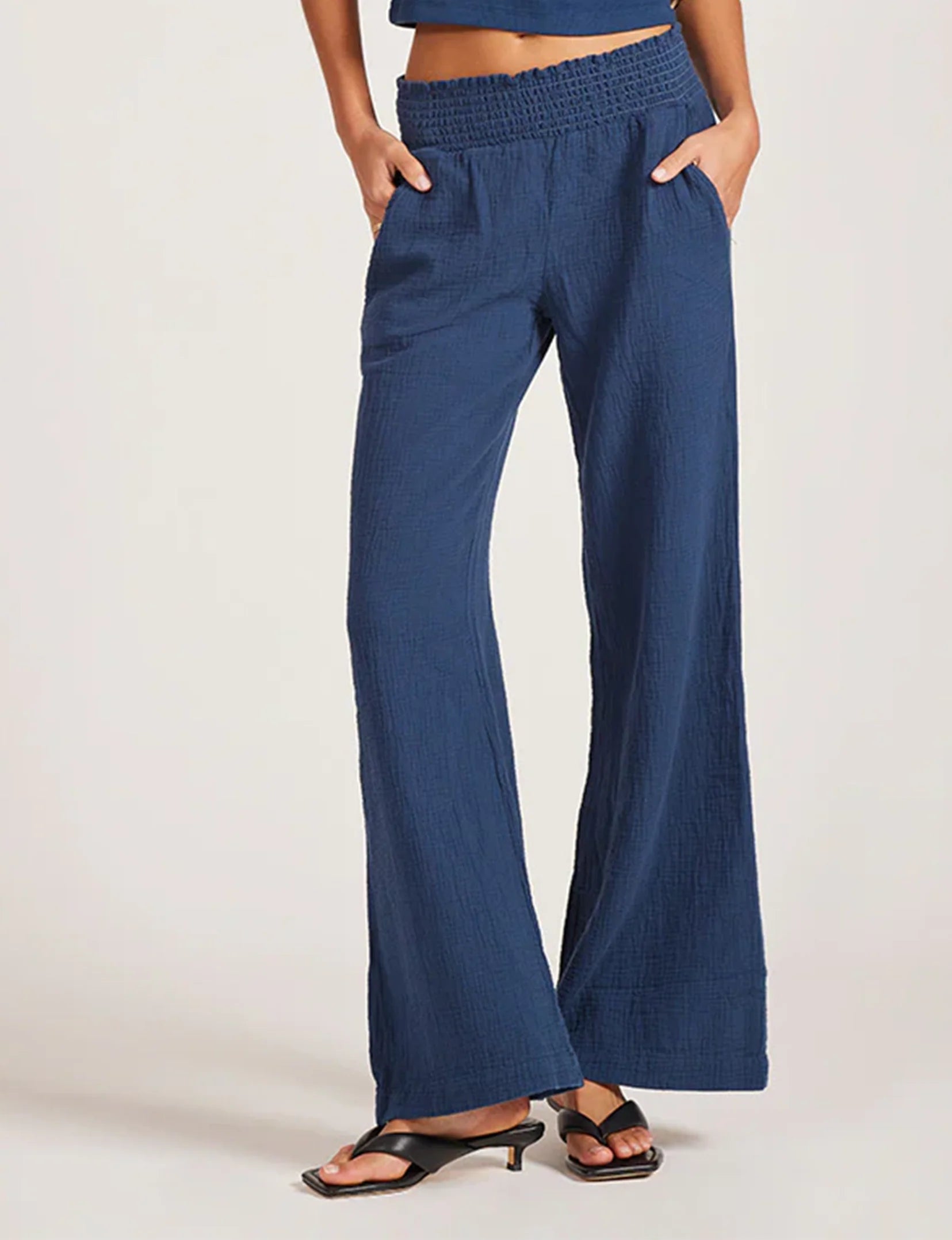 Blue wide-leg pants worn by a person on a white background