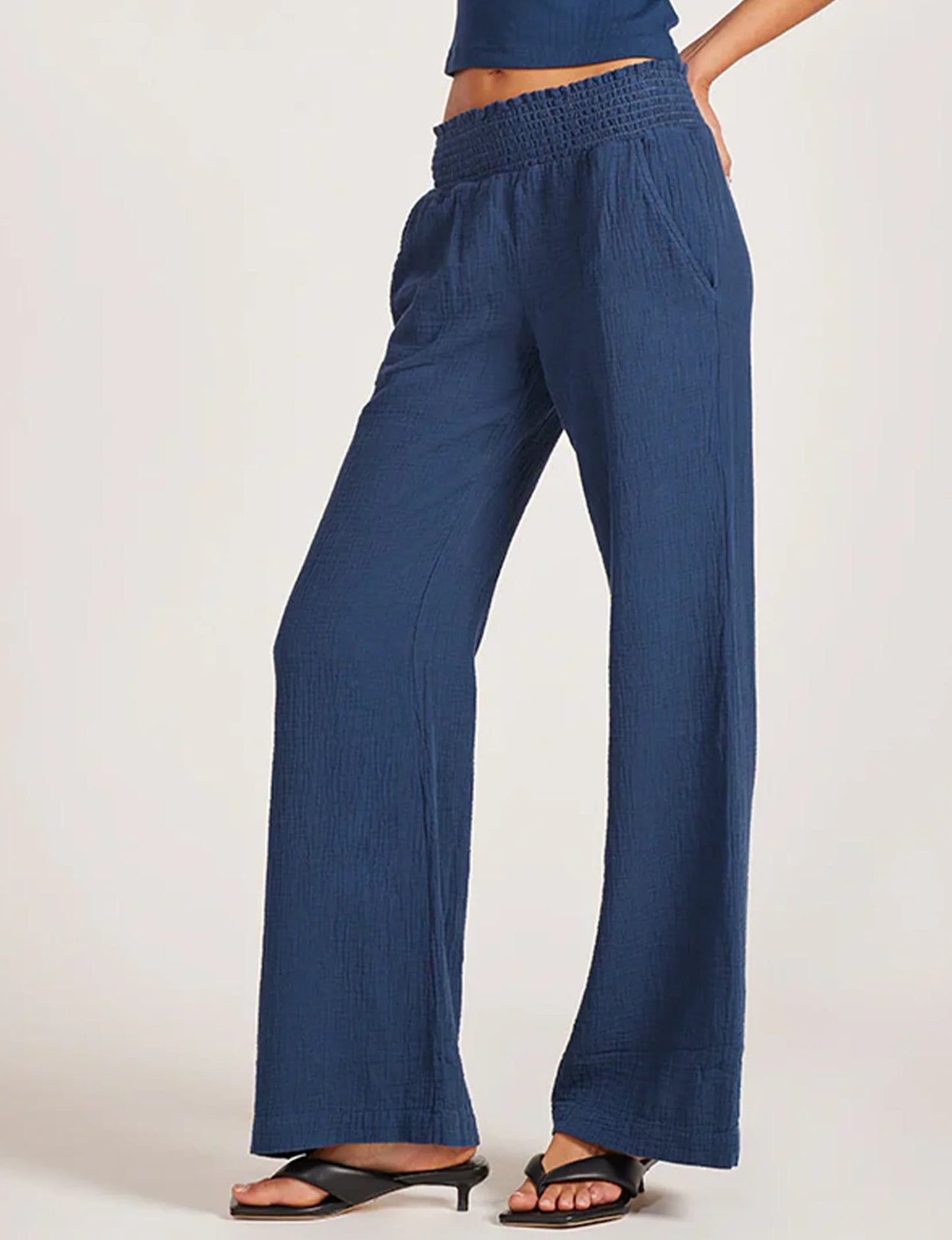 Blue pants worn by a person on a white background