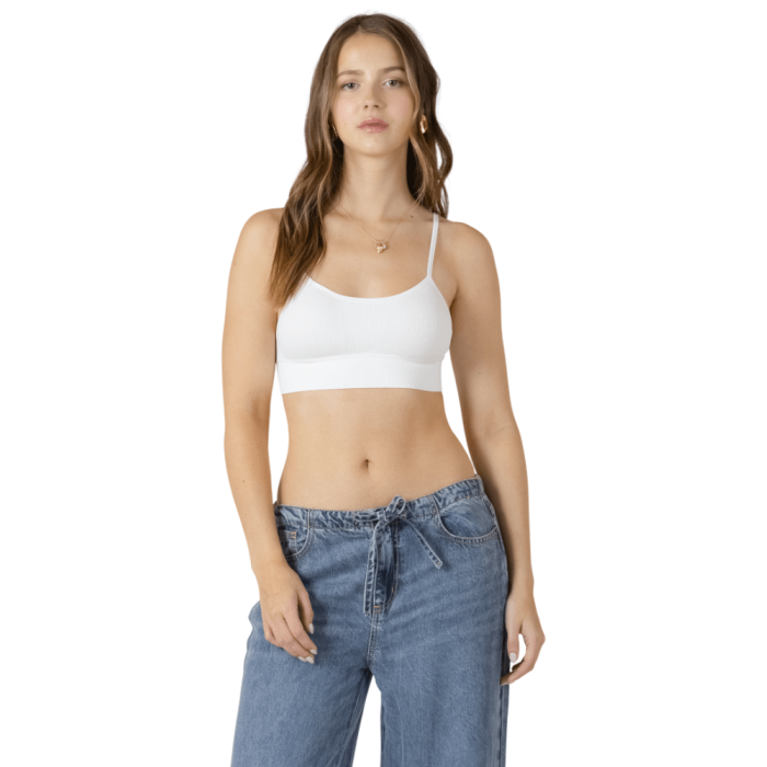 Woman in white tank bra top.