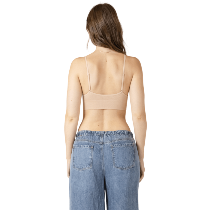 Back of woman in nude tank bra.