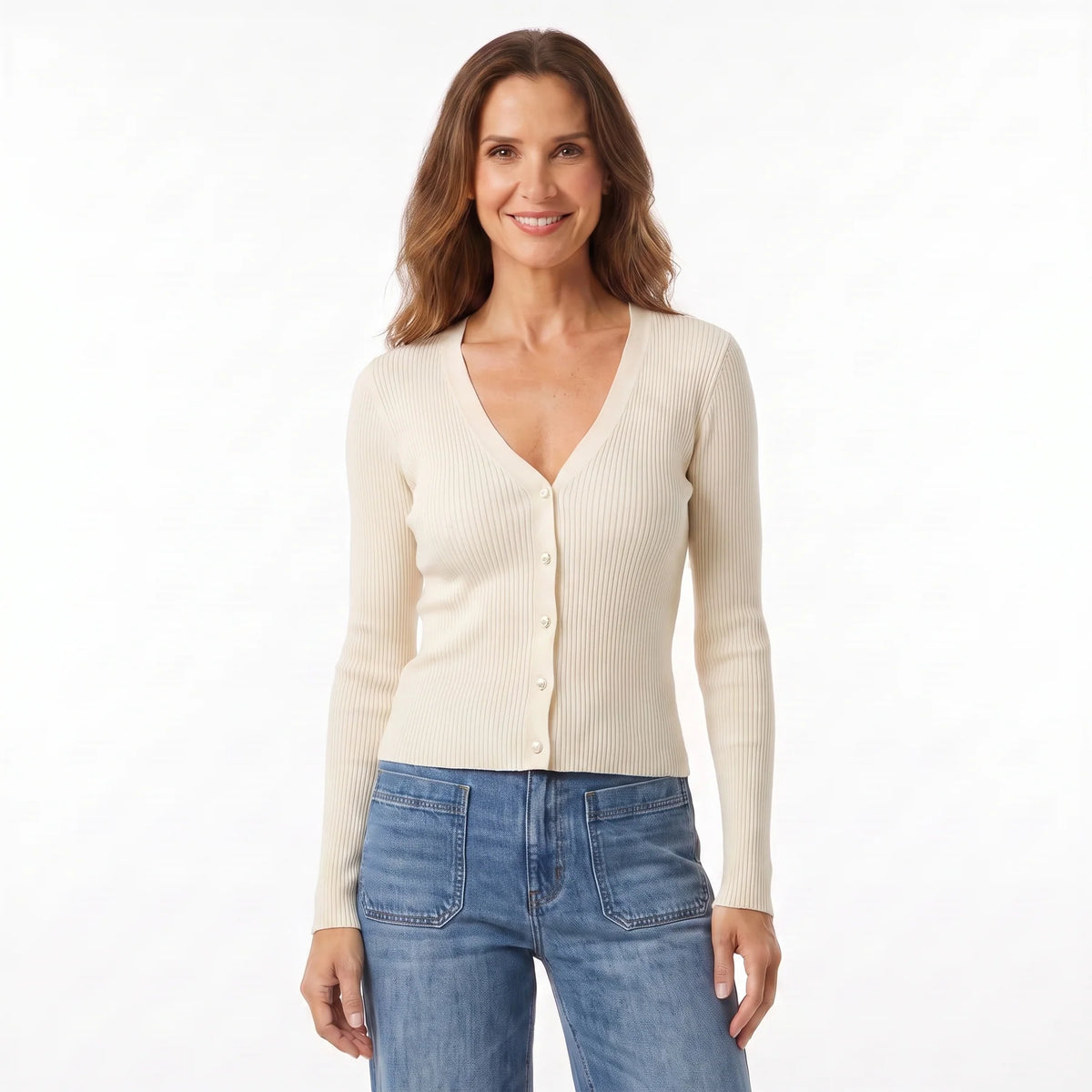 Woman in light cardigan and blue jeans against white background.