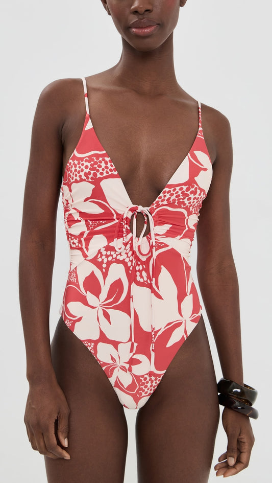 Woman in red one piece bathing suit on white background.