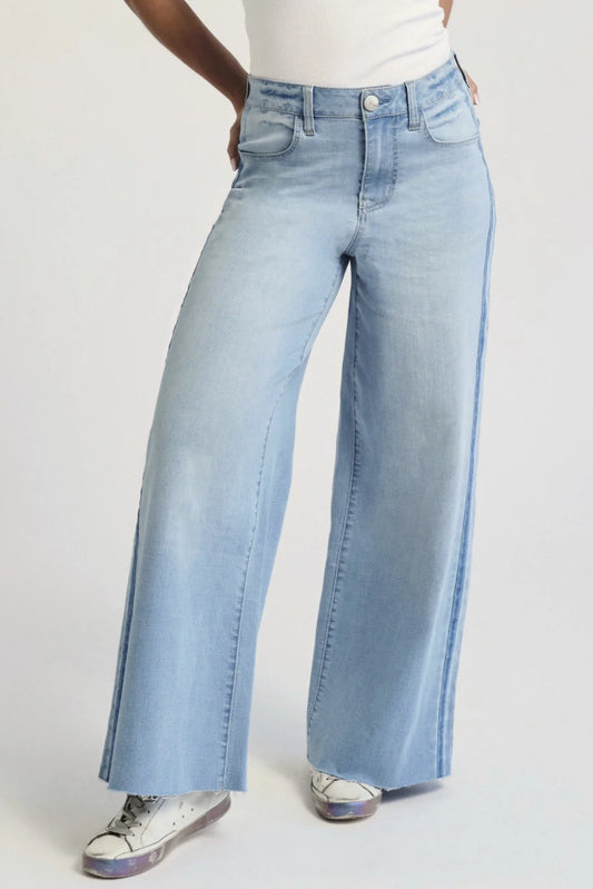 Person wearing denim jeans facing forward.