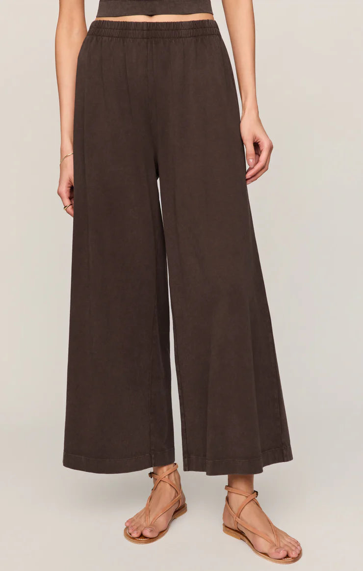 Brown wide-leg pants worn by a person on a plain background