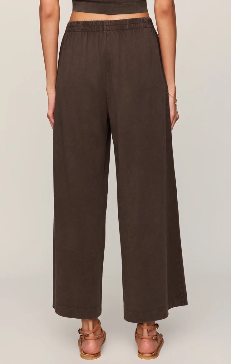 Brown wide-leg pants worn by a person on a plain background
