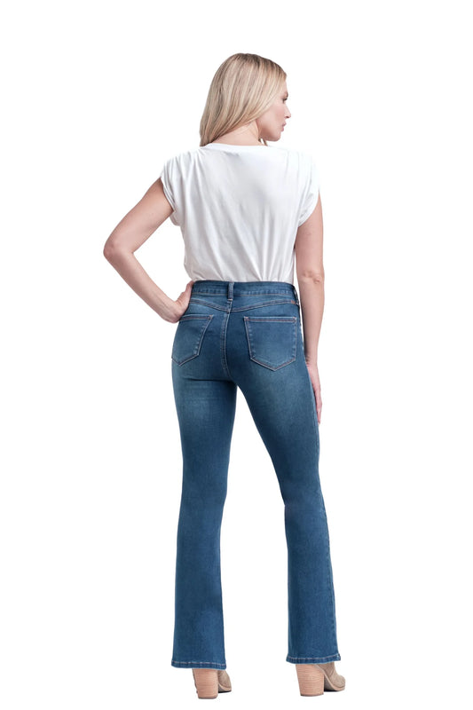 Woman wearing blue jeans and a white top on a white background